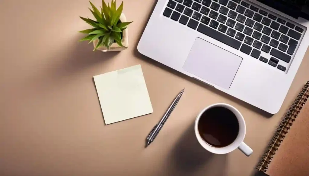 Best SEM expert in Bahrain workspace with laptop, notebook, pen, coffee, and digital marketing planning setup